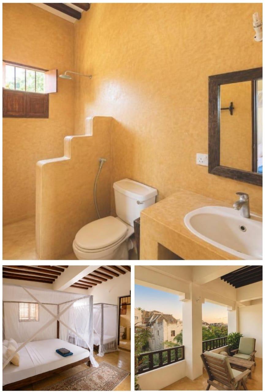 An ochre plaster bathroom with a rain shower, a bedroom under mosquito nets, and a balcony over the rooftops