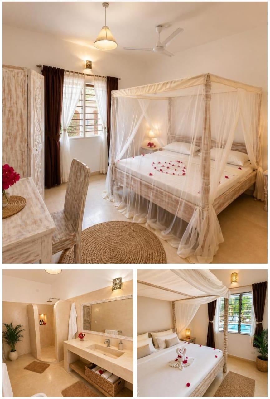 A bright bedroom with a white four-poster bed and mosquito net, and a matching bathroom