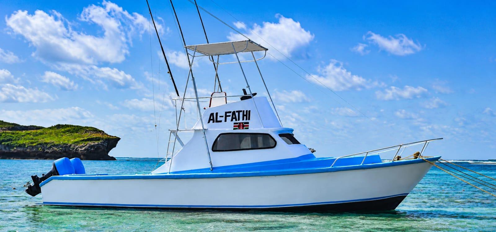 The white and blue Al-Fathi sport-fishing boat with outriggers, moored in turquoise water