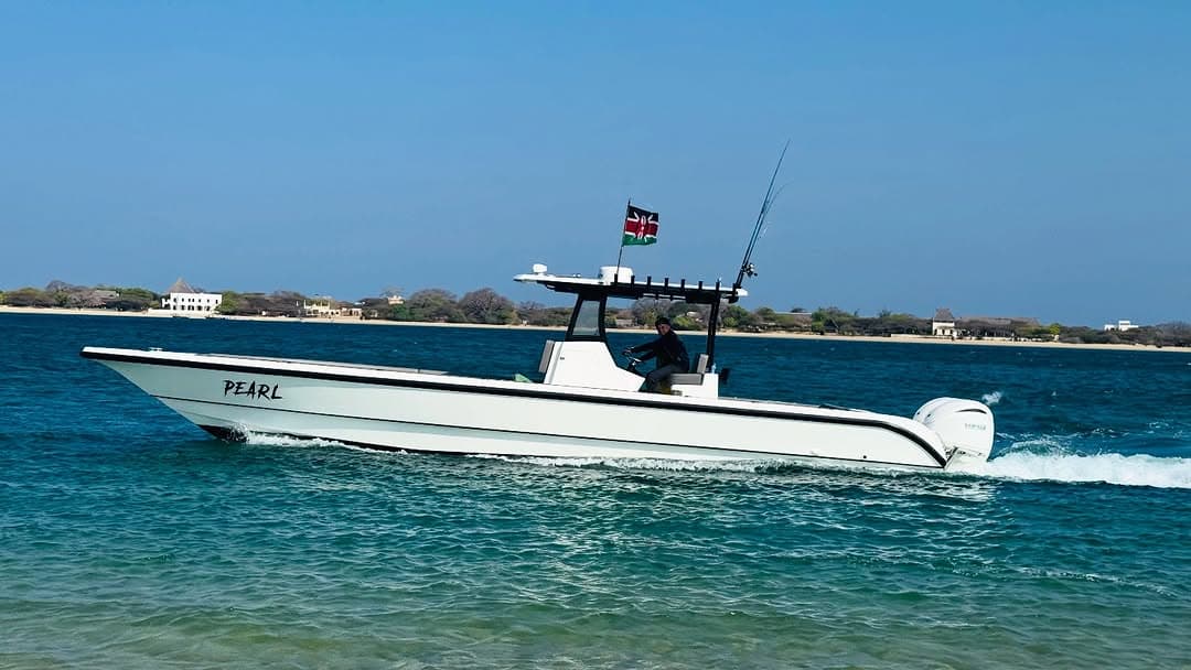 The Pearl, a white centre-console boat with twin outboards, running across the Lamu channel